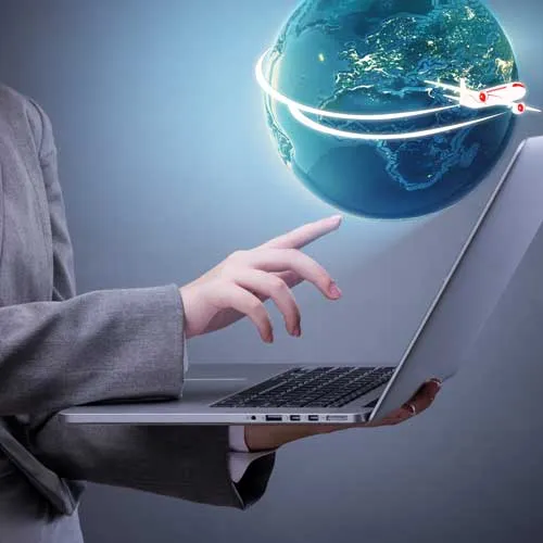 Business woman spins globe above laptop