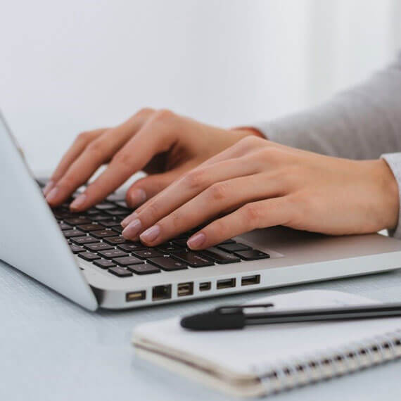 Businesswoman writing on a laptop