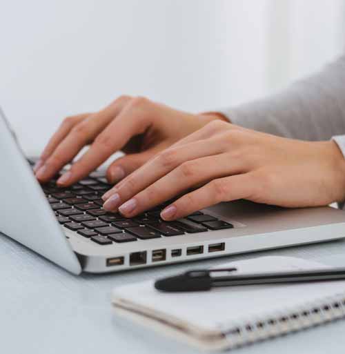 Businesswoman's hands on laptop